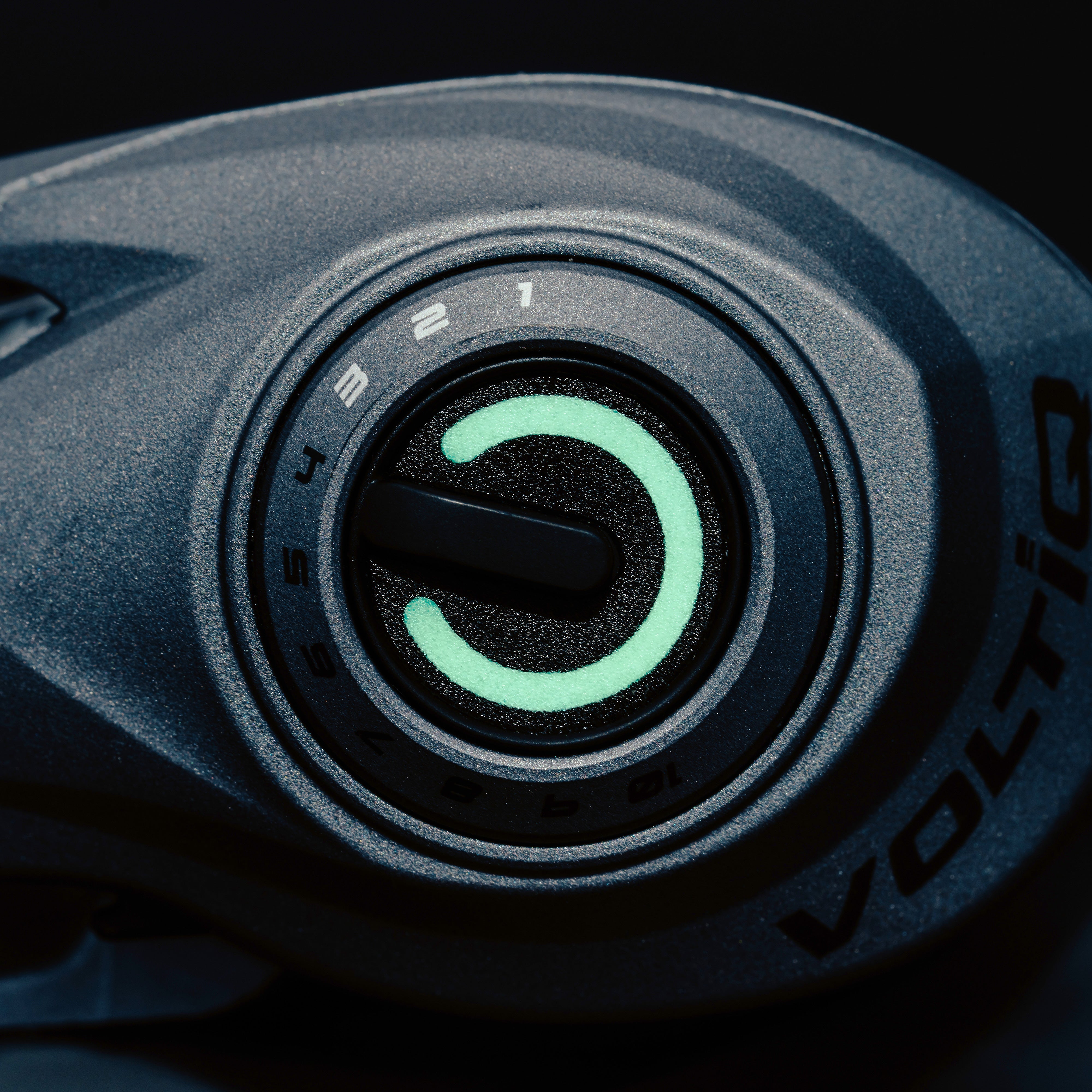 Close-up of a Revo® VoltiQ™ Low Profile Reel knob with a black background. 