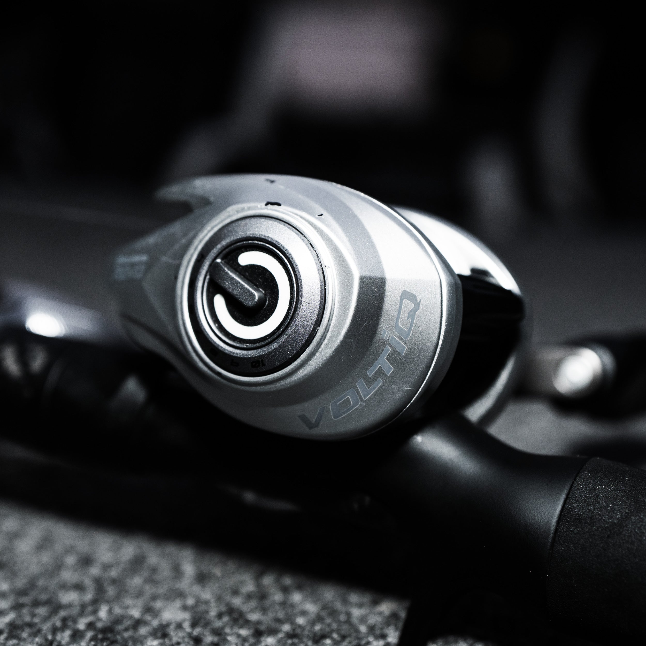 Close-up of a Volto fishing reel handle with blurred background